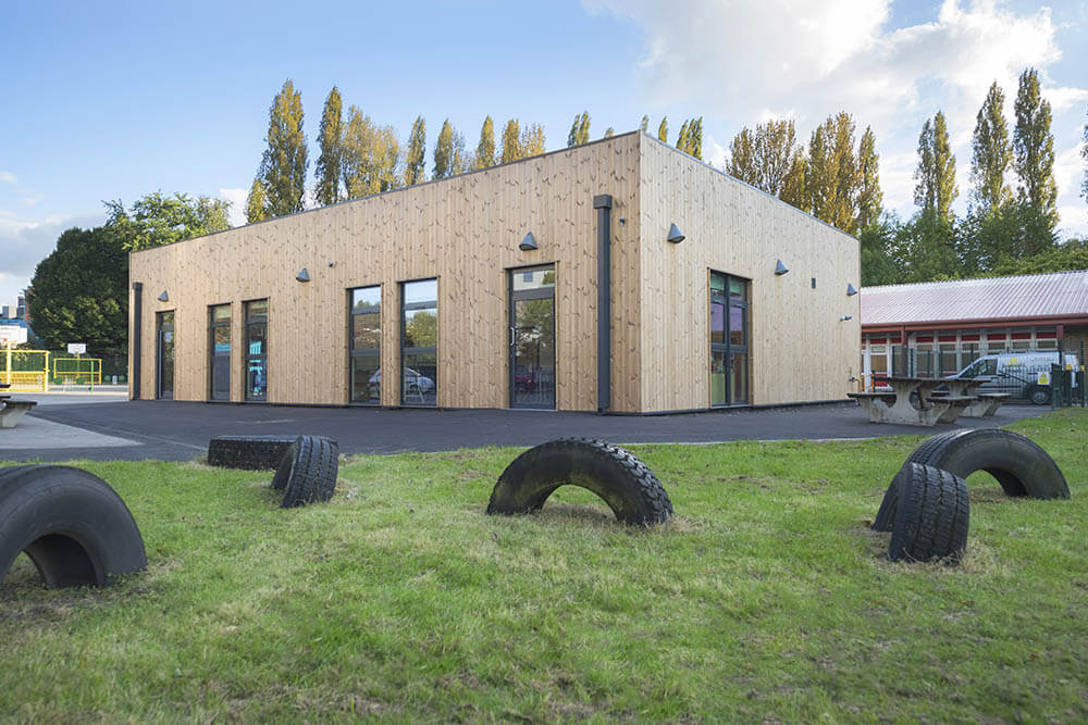 modular school building with tires in grass